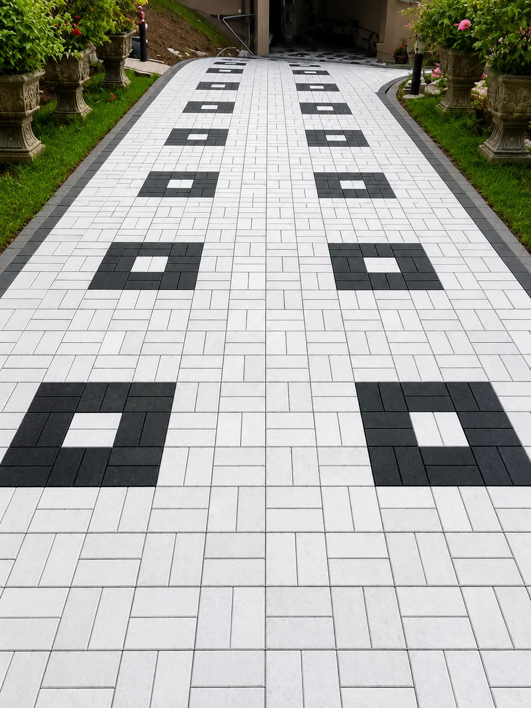 White and black patterned driveway leading to a house porch