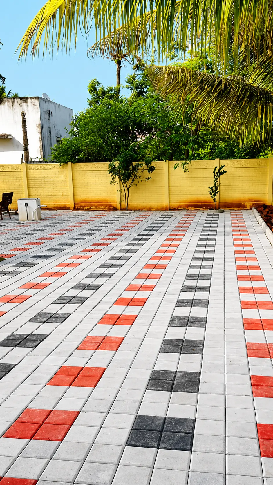 Wide courtyard paved in white blocks with red and black checkered lines